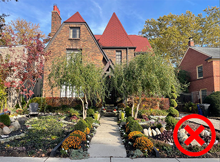 An example of incorrect vegetation shown by 19434 Stratford in the Sherwood Forest Historic District, which shows a lawn with newly planted trees and bushes alongside the center walkway that fundamentally alter the historic character of the house. 