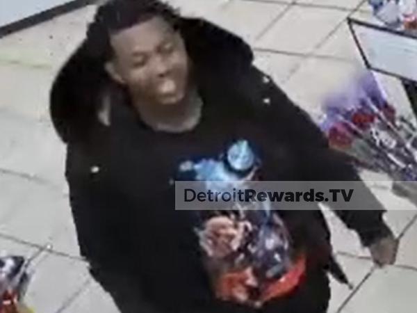 Male suspect wearing a black coat, black graphic t-shirt and black pants.