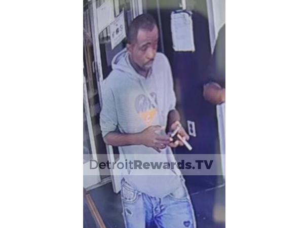 Suspect male wearing a gray sweatshirt and blue jeans.